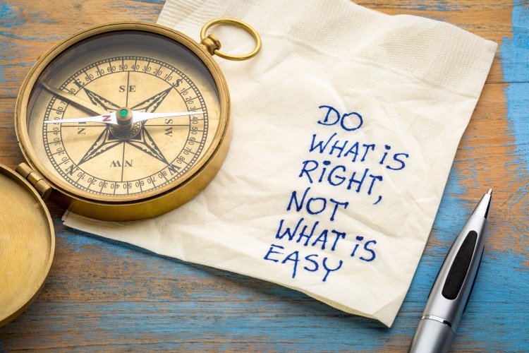 Image of a compass sitting on a napkin with the message "do what is right, not what is easy."